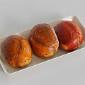 Three Brown And Red Colored Bread With Cracked Surface Placed On White Rectangular Tray 3d model