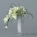 Beautiful White Flower Arrangement In Vase With Green Leaves And White Ribbon