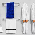 Blue And White Towels With White Bathrobes On Bathroom Towel Rack
