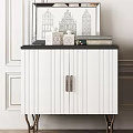 White Entryway Cabinet And Sideboard With Gold Metal Legs Black Countertop And Decorative Items