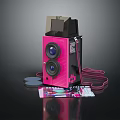 Pink Digital Camera With Vintage Style Design And Film Rolls Near Colorful