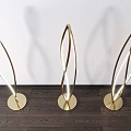 Golden Curved Modern Floor Lamps Illuminated With Shadow On Wooden Floor White Wall