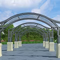 Modern Arched Pergola With Supporting Columns Green Trees And Blue Sky
