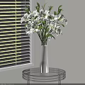 White Vase with White Lilies on Glass Round Table by White Blinds
