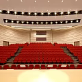Cultural Center Auditorium Interior With Red Seats Stage Blue Screen Red Curtains And Ceiling Lights