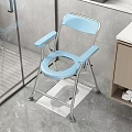 Blue Folding Toilet Chair In Bathroom With Non Slip Mat And Wooden Cabinet