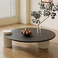Modern Round Black Coffee Table with Fruit Bowl White Vase Green Plant on Wooden Floor