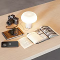 Open Books and Magazines on Wooden Table with Lamp Camera Notebook and Mobile Phone