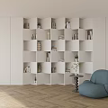 White Modular Bookshelf With Compartments Books Plants Next To Blue Beanbag Chair On Wooden Floor