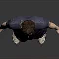 Man in V neck T shirt and shorts standing with sneakers on dark background