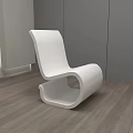 White Modern Leisure Chair With Sleek Lines In Interior Gray Walls Wooden Floor