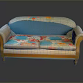 Spacious Vintage Sofa With Curved Armrests Colorful Floral Cushions And Light Wooden Legs
