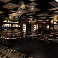 Stylish Restaurant Interior With Hanging Chandeliers Dining Tables Wine Racks And Green Plants