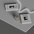 White Fang Books by Jack London Displayed on Gray Tabletop With Silver Flower Ornament
