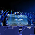 Futuristic Stage Setup With Large Screen Blue Lighting And Audience Seats 3d model