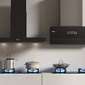 Modern Kitchen Appliances Featuring Black Range Hoods Gas Stoves And Cookware On Countertop
