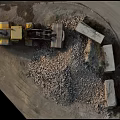 Yellow Loader Near Large Gravel Pile With Stone Blocks At Construction Site