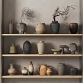 Collection of Assorted Ceramic Vessels on Wooden Shelves with Decorative Branches and Neutral Hues