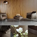 Brown Leather Armchairs In Living Room With Wooden Wall Coffee Table And White Flowers
