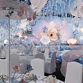 Elegant Banquet Hall With Floral Decorations Hanging Installations And White Chairs