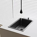Modern Black Drop Shaped Faucet Over Stainless Steel Sink On White Countertop With Window Blinds