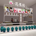 Flower and Fruit Drinks Shop in Mall With Arranged Blue Green Bottles and Display Counter