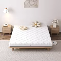 Cozy Bedroom Interior With White Quilted Mattress Wooden Bed Frame Nightstands And Flower Pillows