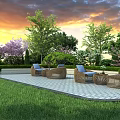 Outdoor Wicker Sofas On Patio With Green Lawn And Trees Against Sunset Sky