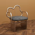 Cloud Shaped Metal Leisure Chair With Gray Padded Seat And Armrests On Wooden Herringbone Floor