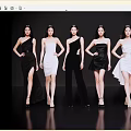 Group of Women in Stylish Black and White Dresses Posing Gracefully on Black Background