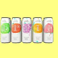 Colorful Canned Fruit Drinks with Various Flavors and Fruit Patterns on Yellow Background