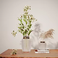 Transparent Vase With White Flowers Green Leaves And Smaller Vase Dried Grass On Wooden Table CHANEL Book Light Background