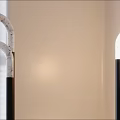 Modern Interior Floor Lamp With Curved White Light And Black Base On Wooden Floor