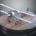 Silver Biplane Fighter Aircraft Model With Propeller On Circular Display Base 3d model