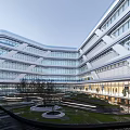 Modern Office Building With Glass Curtain Walls Geometric Structure And Landscaped Water Feature