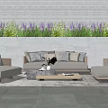 Outdoor Modular Sofa With Cushions And Woven Details By Stone Wall And Lavender Flowers