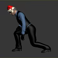 Man Wearing Santa Hat Blue Shirt And Black Vest Crouching On Gray Background