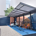 Bicycle Parking Area with Shelter Motorcycle and Bikes on Blue Floor Near Building and Tree