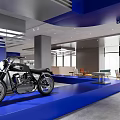 Modern Exhibition Hall Interior With Vintage Motorcycle Blue Curved Structure Wooden Floor And Display Cabinets