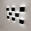 Black Square Wall Lamps in Irregular Arrangement Illuminated on White Wall with Soft Light