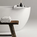 Elegant White Freestanding Bathtub With Wooden Bench Towels And Toiletries