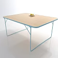 Modern Coffee Table With Wooden Surface And Metal Legs Holding Two Fruits On Top