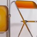 Two Folding Leisure Chairs With Yellow Seat Backrest And Chrome Metal Frame Against Wall