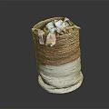 Woven Storage Basket With Brown And White Design Holding Decorative Fabric Items