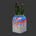 Paintbrushes in Colorful Vase With Blue Red White Paint Splatters On Dark Background