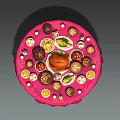 Round Dining Table with Pink Tablecloth Filled with Roast Chicken Bowls Plates and Small Decorations