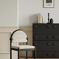 Light Upholstered Dining Chair With Dark Frame And Dark Chest Of Drawers Against Neutral Wall