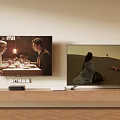 Two Modern Televisions Mounted on Wall With Wooden Shelf Displaying Different Scenes 3d model