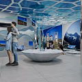 Cultural Center Interior With Visitors Exploring Exhibition Murals Digital Screens And Decorative Flags