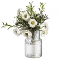 White Flowers Arrangement In Textured Glass Vase With Green Leaves And Purple Accents
